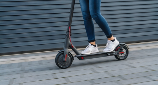 Woman riding black electric scooter