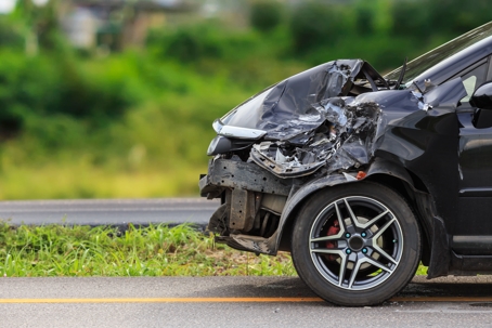 front of black car getting smashed up after a collision